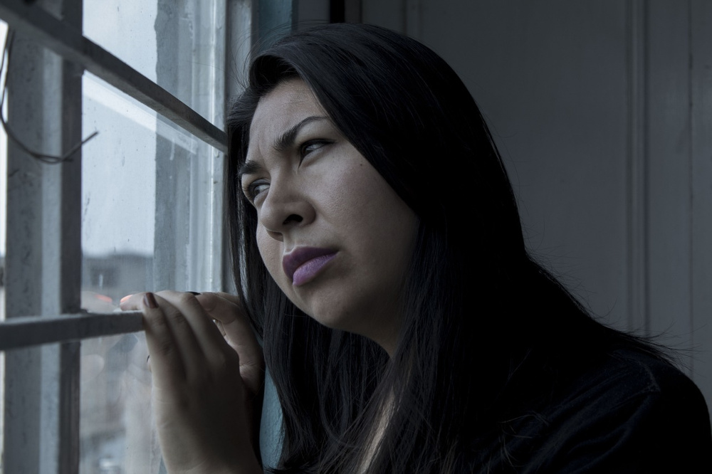 Sad woman at window