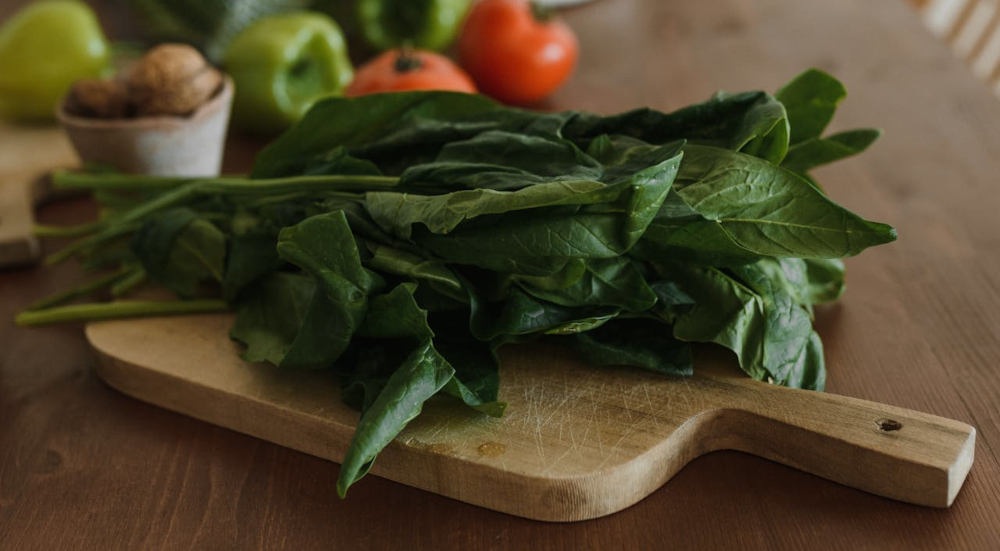 Leafy greens on wooden cutting board